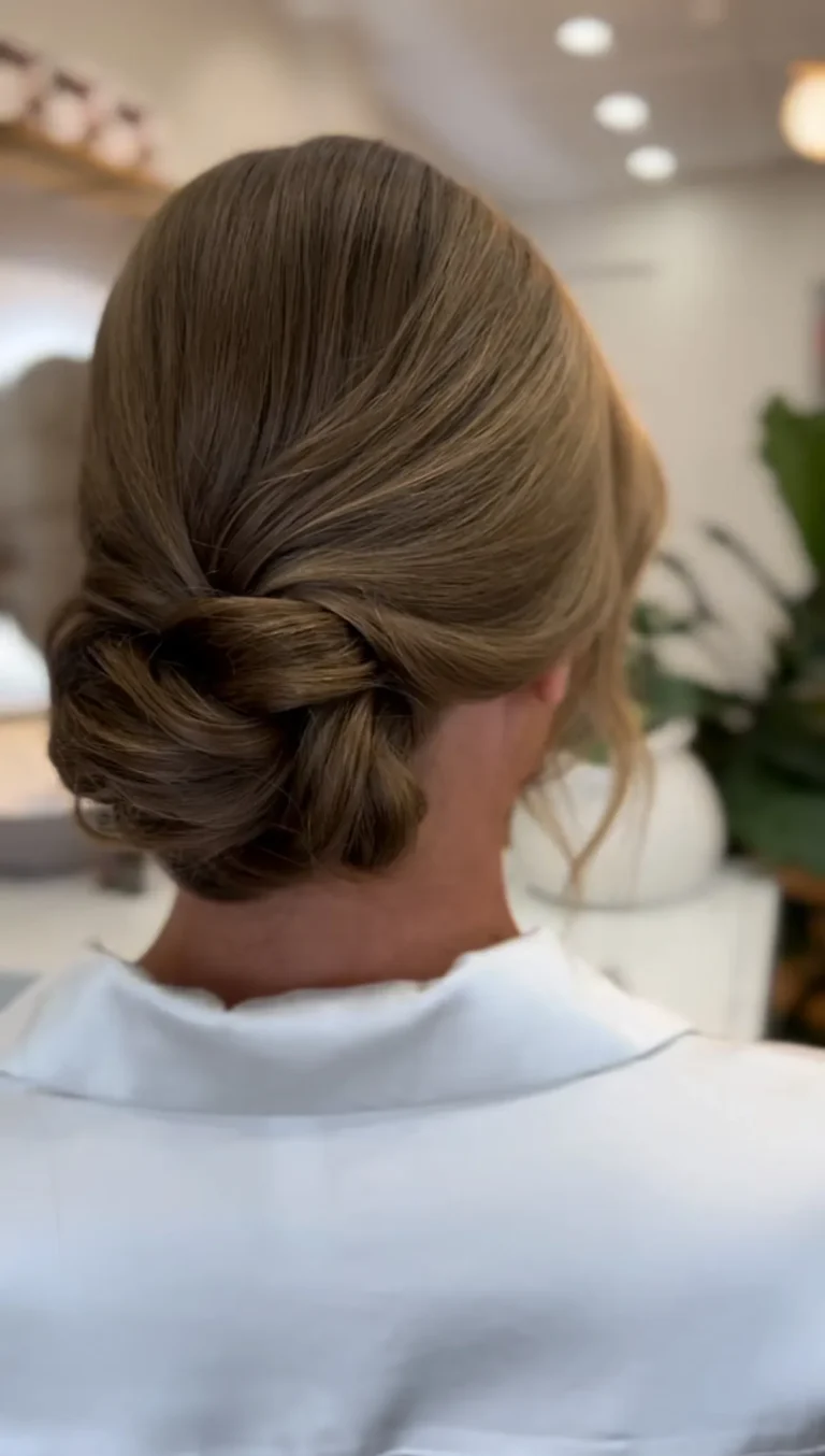 Elegant bridal updo from the back with smooth detailing.