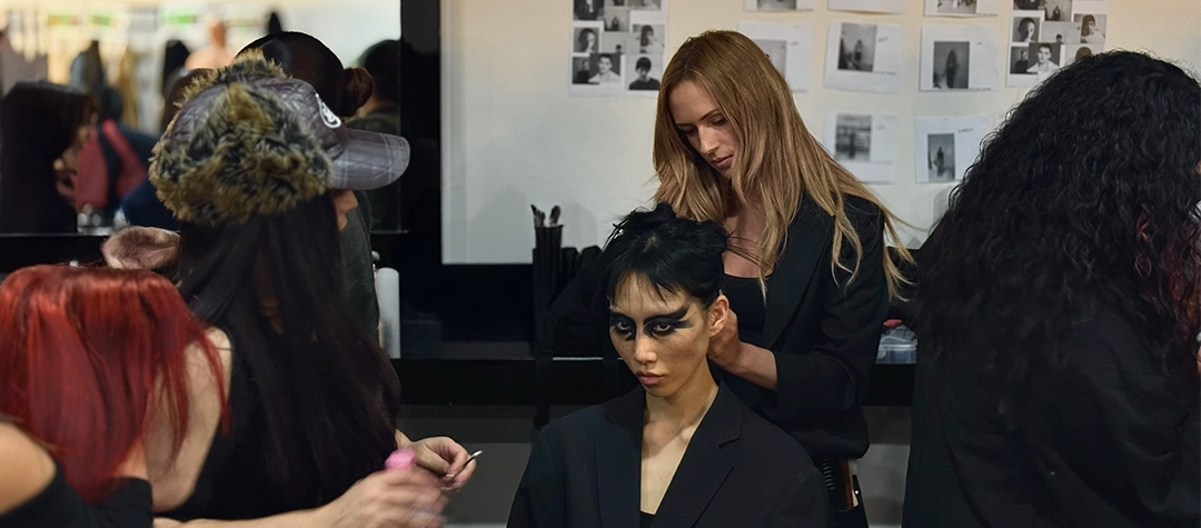 hairstylist and makeup artist preparing model backstage at Speed Show